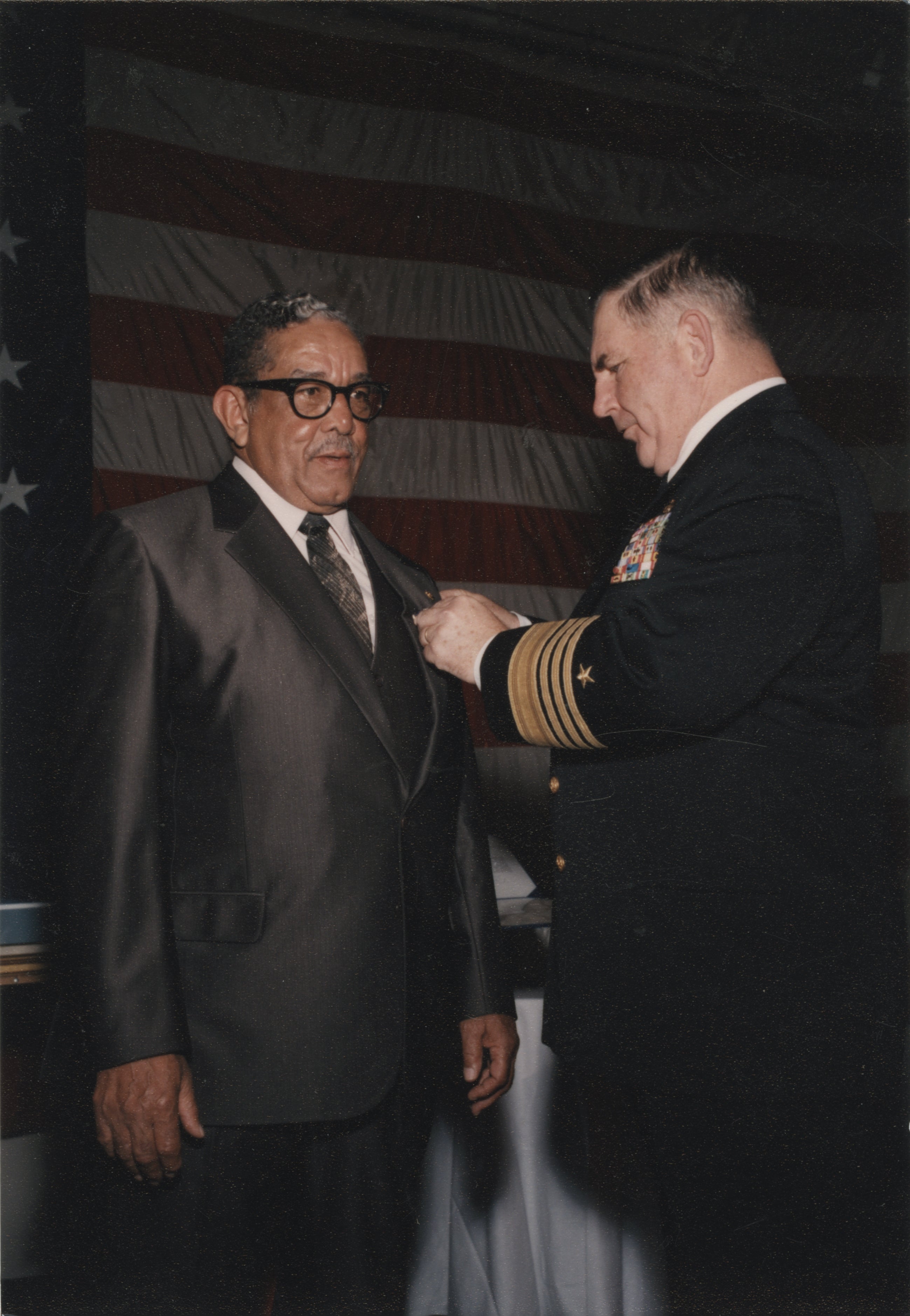 Man receiving Navy Cross during a heartfelt ceremony aboard the Intrepid in 1993