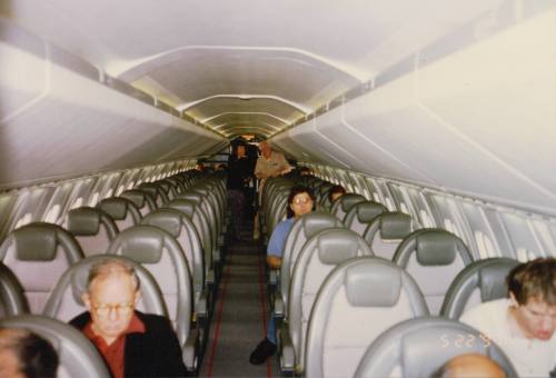 The British Airways Concorde main cabin features a 2-2 seating arrangement, with passengers seated and some empty seats visible. 