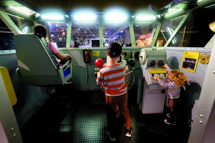 Three children playing in the Exploreum.