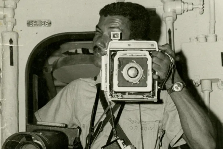 an old image of a man taking a picture using a camera