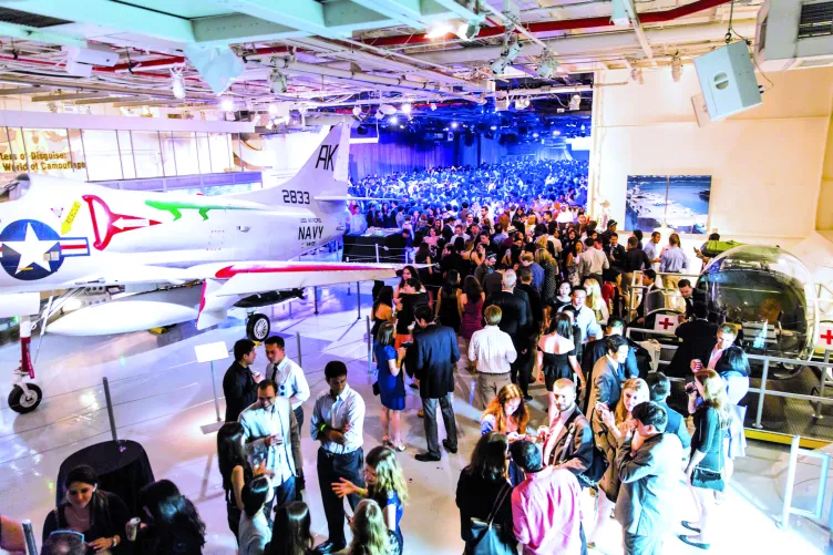 Guests at an event mingling on the hangar deck