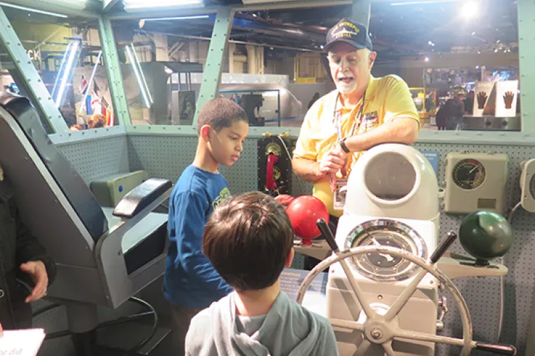 military family appreciation month image of veteran talking to children