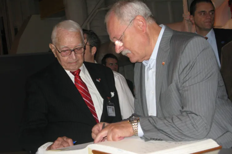 His Excellency, Ivan Gasparovic jots his thoughts on the Intrepid in the museum’s guest book