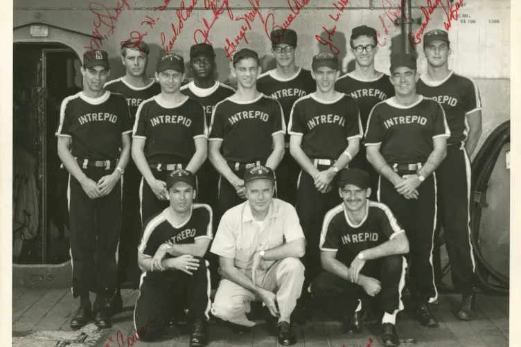 Signed photo of Intrepid’s softball team posting with the ship’s captain.