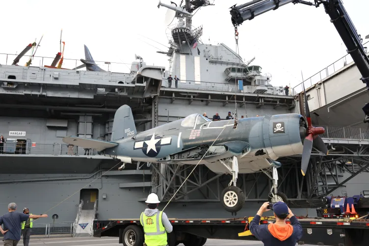 Corsair aircraft suspended on a crane at Pier 86, Intrepid Museum.