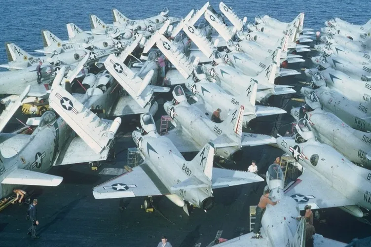 Aircraft on a carrier deck in the ocean.