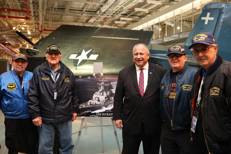 Mr. Del Toro Del Toro and four formal crew members standing in the hangar deck at the Intrepid Museum 