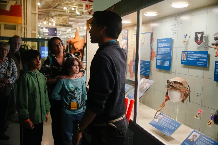 A group of visitors at the museum participating in a group tour.