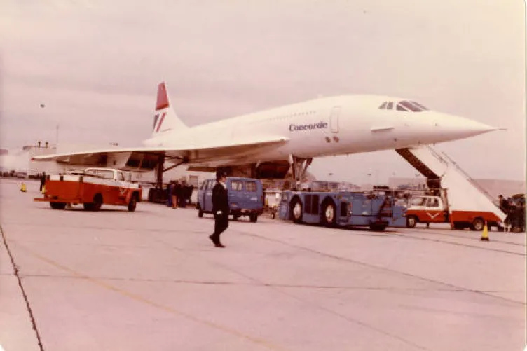 British Airways Concorde docked with cargo around it.