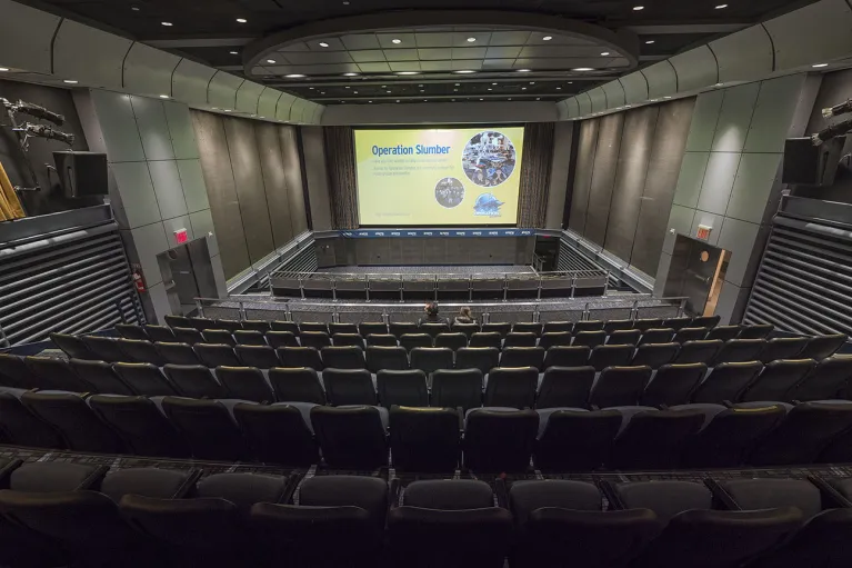 Theater seating facing large theater screen