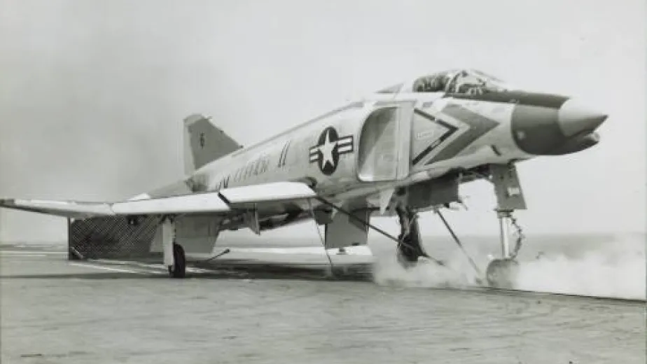 A jet plane sits on the flight deck, ready to be launched.