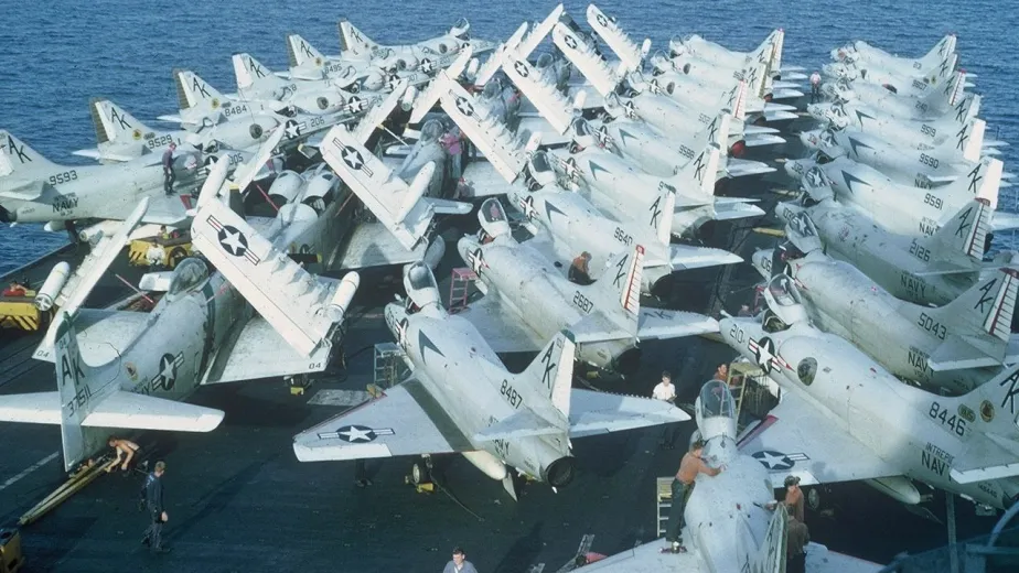 Aircraft on a carrier deck in the ocean.